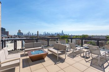 Rooftop with skyline views, grills, and fire pit